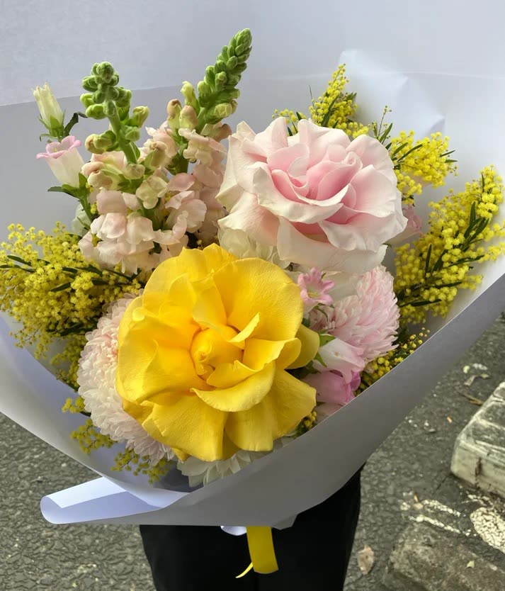 Current ad: yellow rose and wattle bouquet in white wrap
