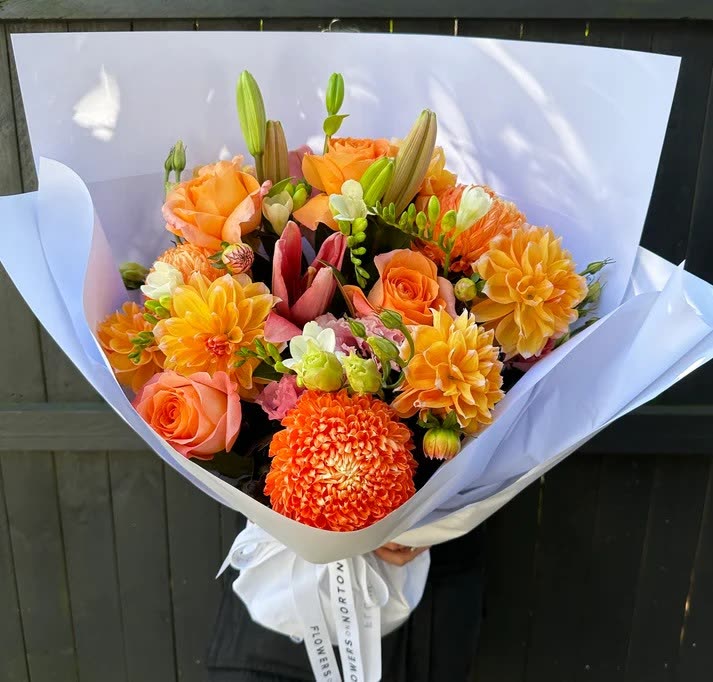 Current ad: orange dahlia bouquet in white wrap