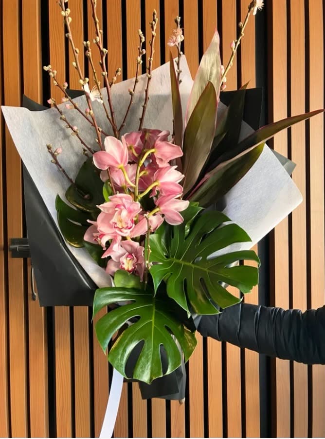Current ad: pink cymbidium with monstera leaves