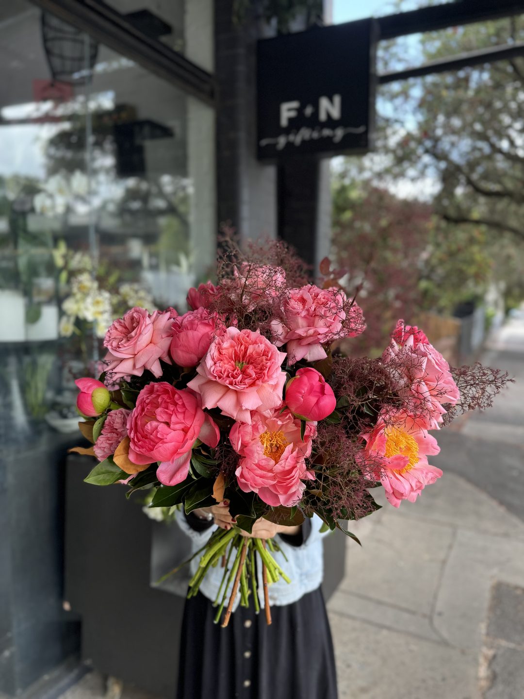 A pink bunch held up outside the Norton St shop